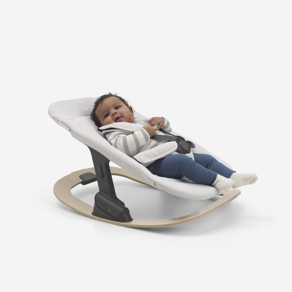 Bugaboo Giraffe Baby Rocker Polar white with baby in it